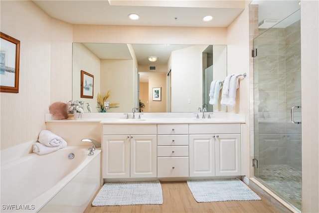 bathroom with vanity, wood-type flooring, and independent shower and bath