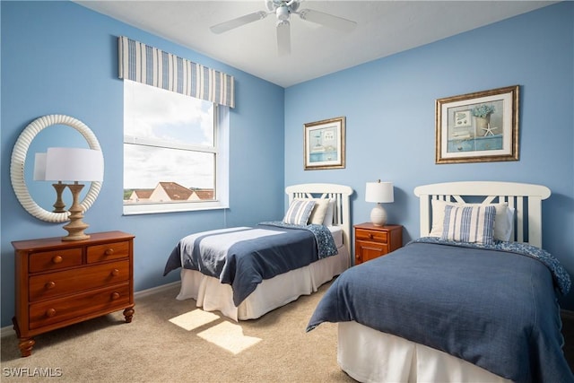 bedroom with ceiling fan and light carpet