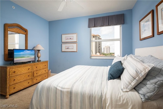 bedroom featuring light colored carpet and ceiling fan