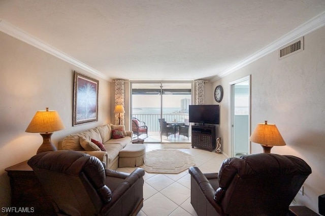 living room with light tile patterned floors and crown molding