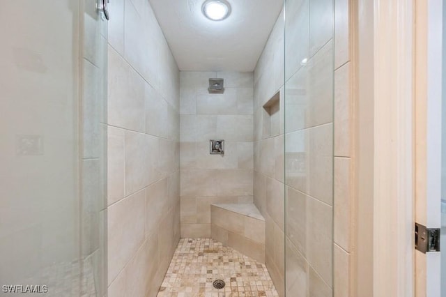 bathroom with a tile shower