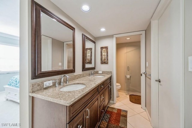 bathroom with tile patterned flooring, vanity, and toilet