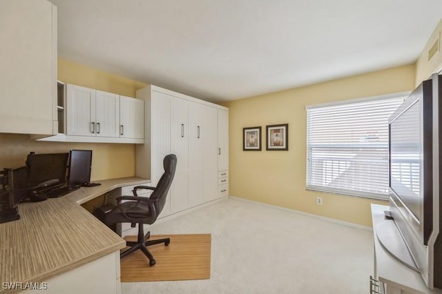 carpeted home office with built in desk