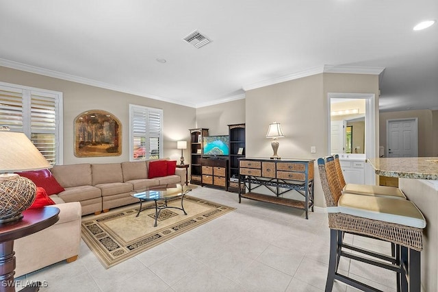 living room with light tile patterned floors and ornamental molding