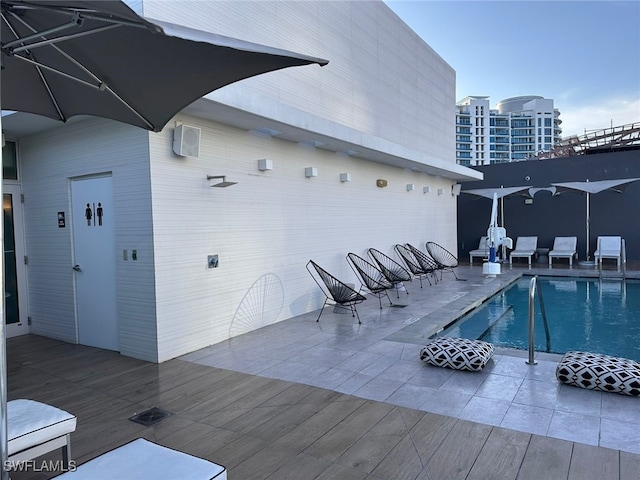 view of swimming pool with a deck