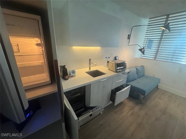 kitchen featuring hardwood / wood-style flooring and sink