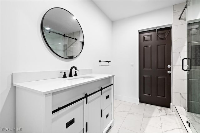 bathroom featuring a shower with shower door and vanity