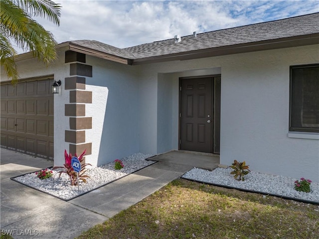 view of exterior entry with a garage