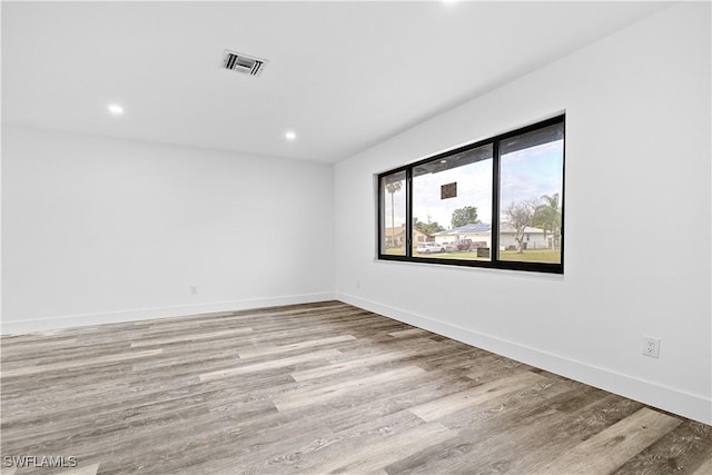 spare room with light hardwood / wood-style floors