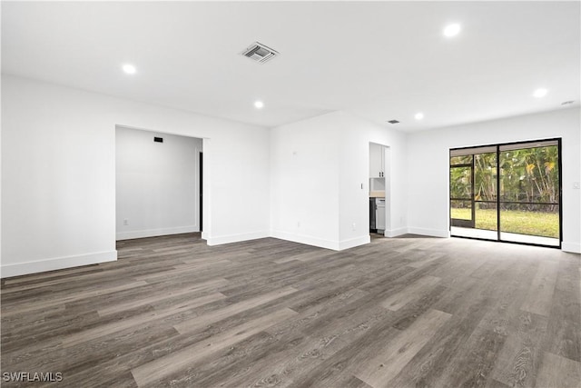 unfurnished living room featuring dark wood-type flooring