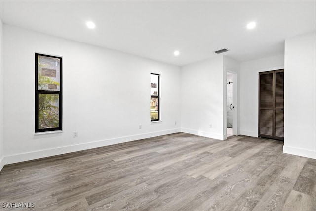 unfurnished room with light wood-type flooring and plenty of natural light