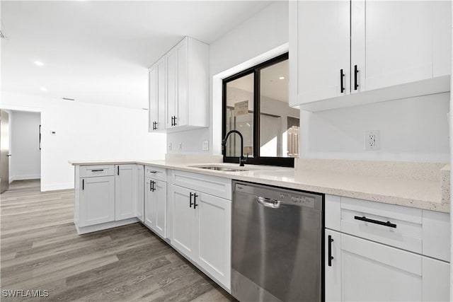 kitchen with white cabinetry, light hardwood / wood-style floors, dishwasher, light stone countertops, and sink