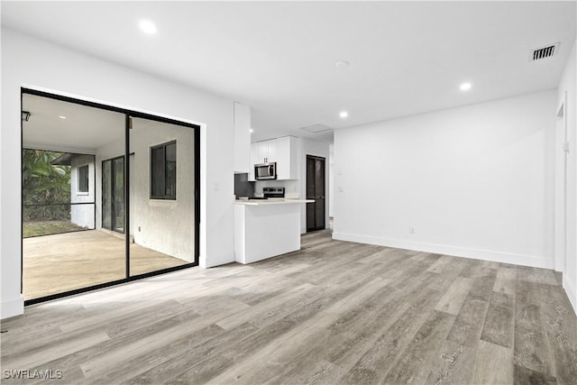 unfurnished living room with light wood-type flooring