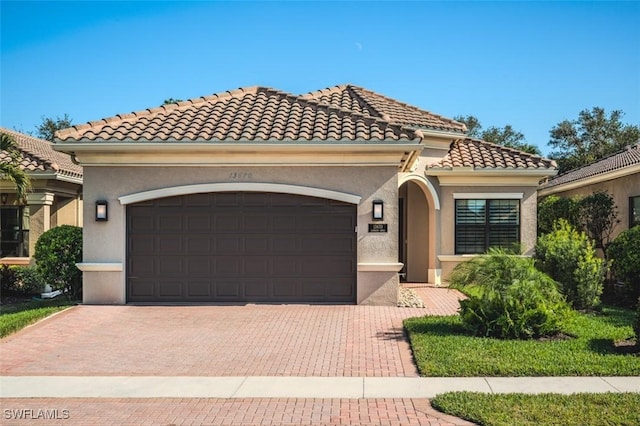 mediterranean / spanish house featuring a garage