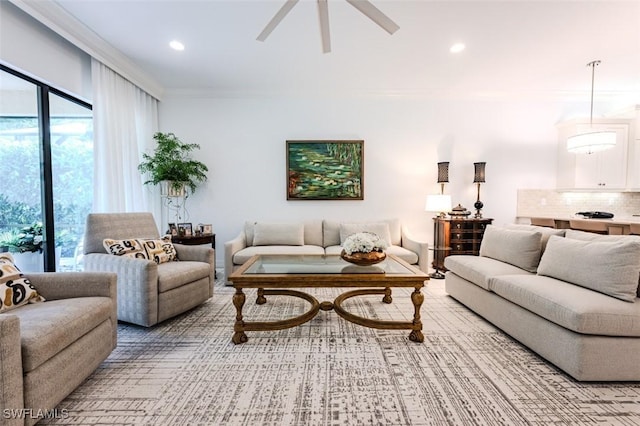 living room featuring ceiling fan and crown molding