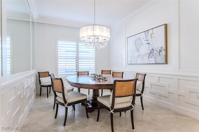 dining room with ornamental molding and a chandelier