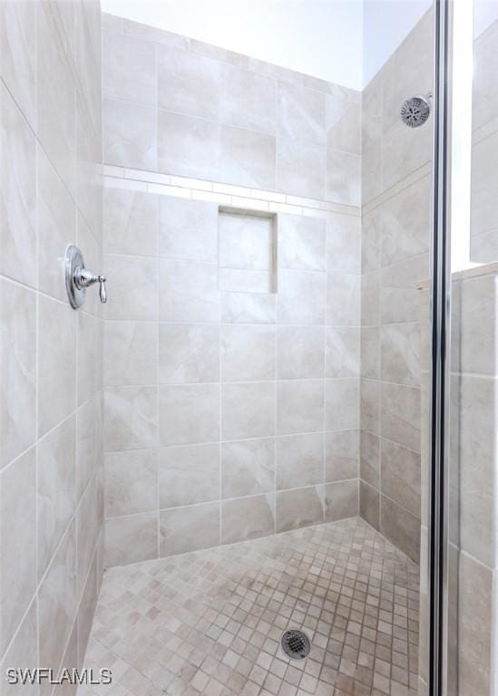 bathroom with tiled shower