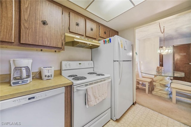 kitchen with a notable chandelier, decorative light fixtures, and white appliances