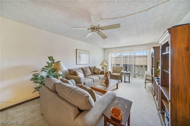 carpeted living room featuring ceiling fan and a textured ceiling