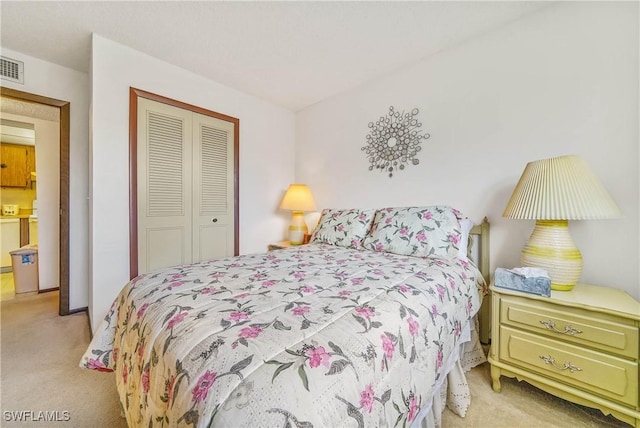 bedroom featuring light carpet and a closet