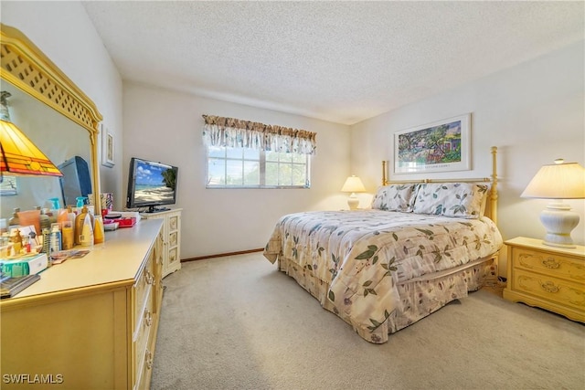 bedroom with a textured ceiling and light colored carpet