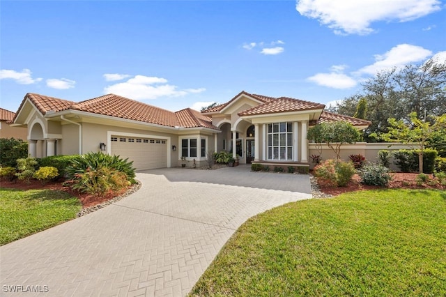 mediterranean / spanish-style house with a front lawn and a garage