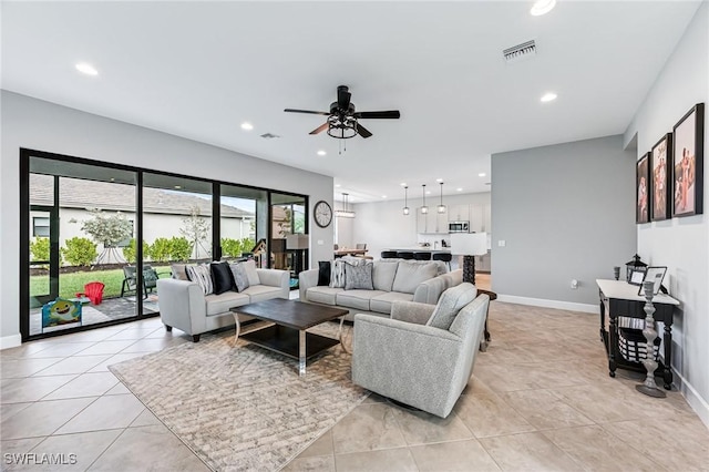 living room with ceiling fan and light tile patterned floors