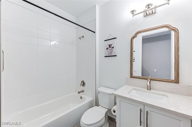 full bathroom with vanity, toilet, and tiled shower / bath combo