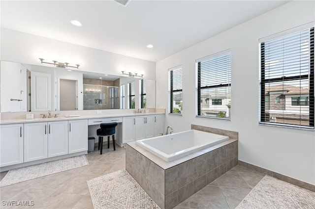 bathroom featuring tile patterned flooring, vanity, and independent shower and bath