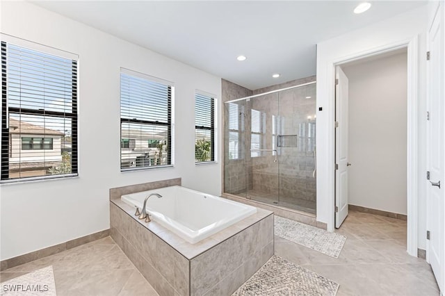 bathroom featuring tile patterned flooring and shower with separate bathtub