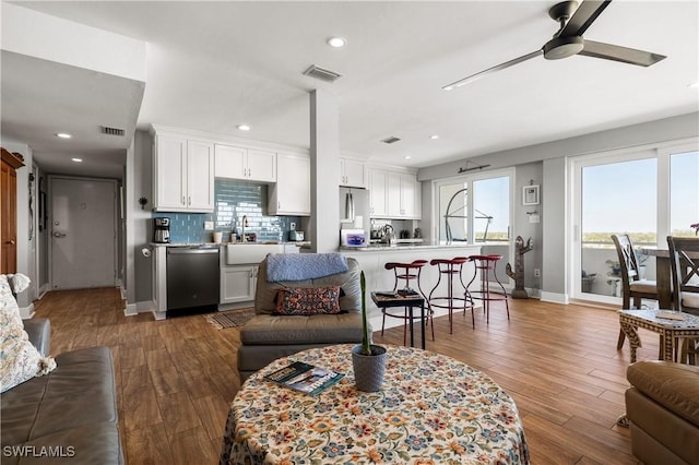 living room with ceiling fan, dark hardwood / wood-style flooring, and sink