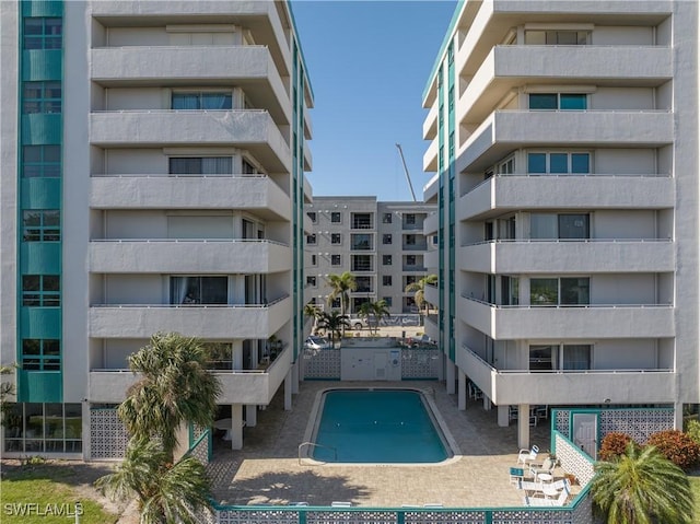 view of building exterior featuring a community pool