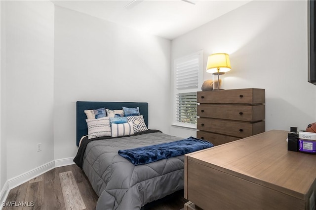 bedroom featuring hardwood / wood-style floors and ceiling fan