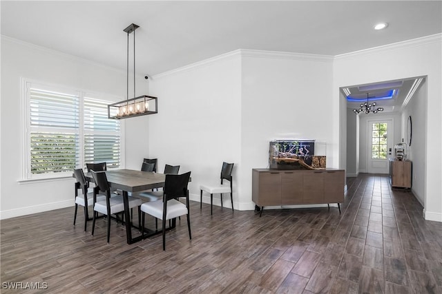 dining room with crown molding and a chandelier