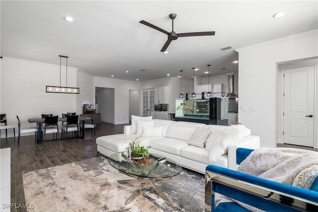 living room with ceiling fan and crown molding