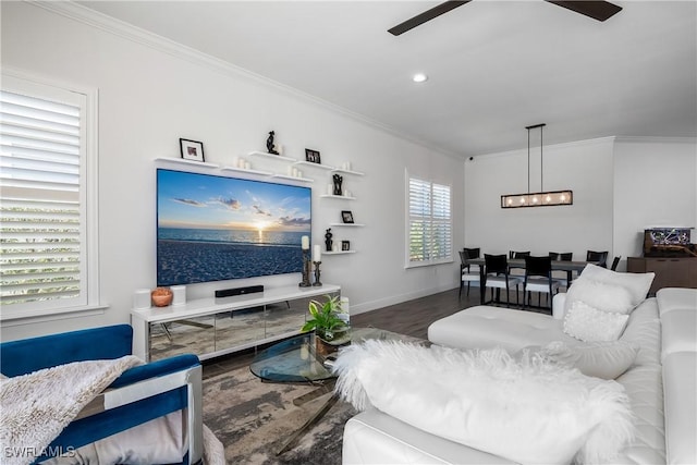 living room with wood-type flooring, ornamental molding, a healthy amount of sunlight, and ceiling fan