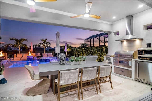 patio terrace at dusk featuring pool water feature, ceiling fan, area for grilling, and grilling area