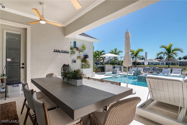 view of swimming pool with ceiling fan, pool water feature, and exterior bar