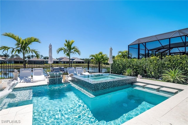 view of pool with pool water feature, a lanai, a water view, and an in ground hot tub