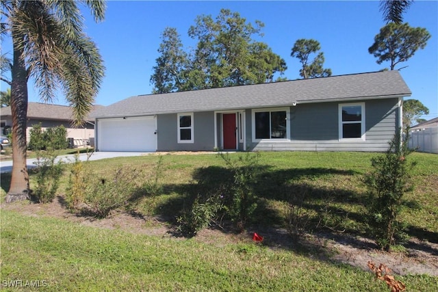 single story home with a front yard and a garage