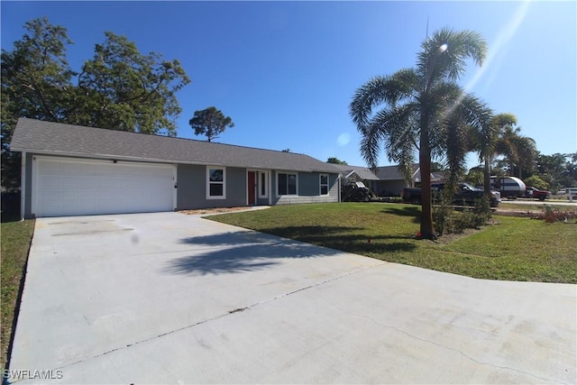 ranch-style home featuring an attached garage, driveway, and a front lawn