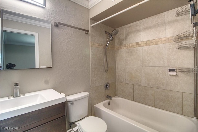 full bathroom with tiled shower / bath, vanity, ornamental molding, and toilet