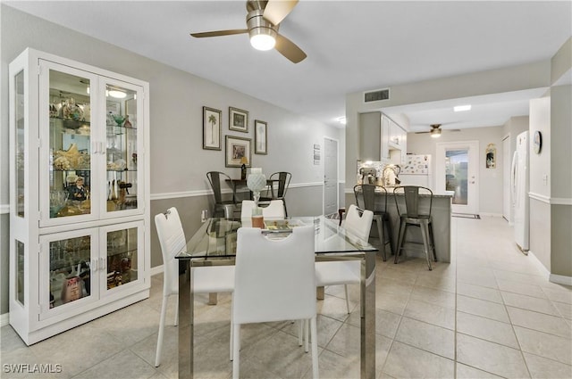 dining space with ceiling fan and light tile patterned floors