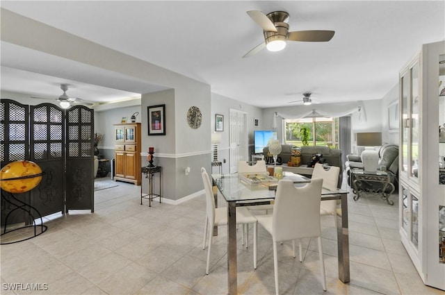 dining space with ceiling fan and light tile patterned floors