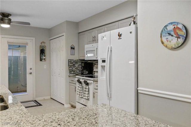 kitchen with light stone countertops, ceiling fan, tasteful backsplash, and white appliances