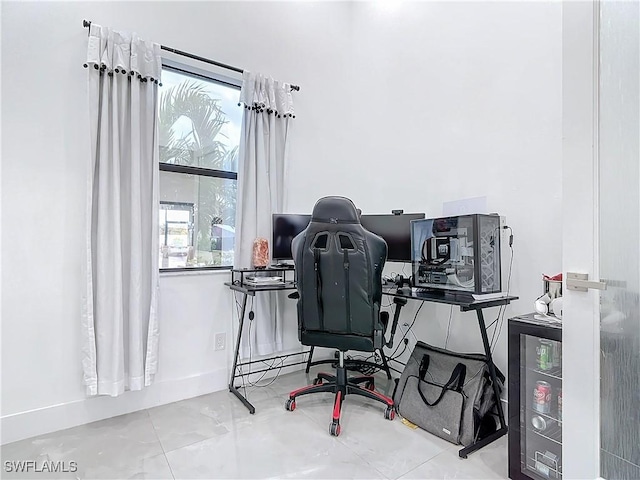 office space featuring plenty of natural light and tile patterned flooring