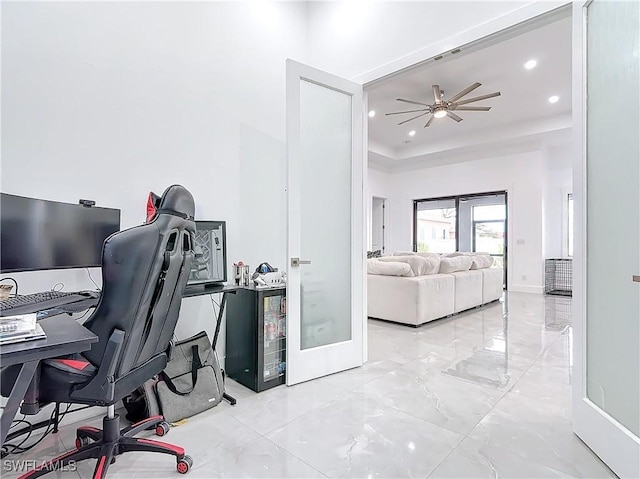 office area with ceiling fan, a raised ceiling, and french doors