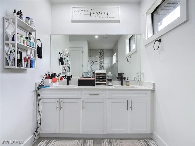 bathroom featuring a shower and vanity