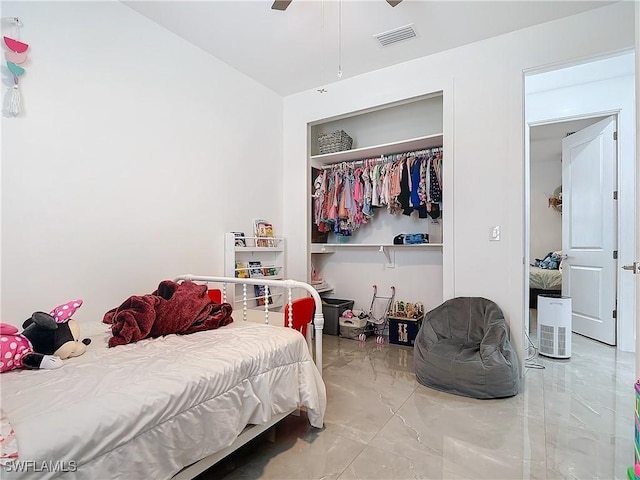 bedroom featuring ceiling fan and a closet