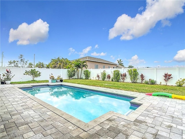 view of pool with a yard and a patio